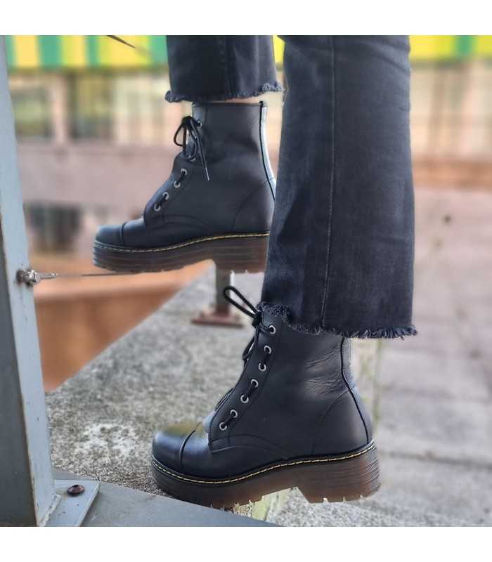Bota militar doble plataforma de piel negra puestas con plantalón negro