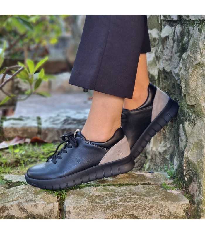 Zapatos negros topo mujer de Renature vistos de perfil en modelo vestida con pantalones negros