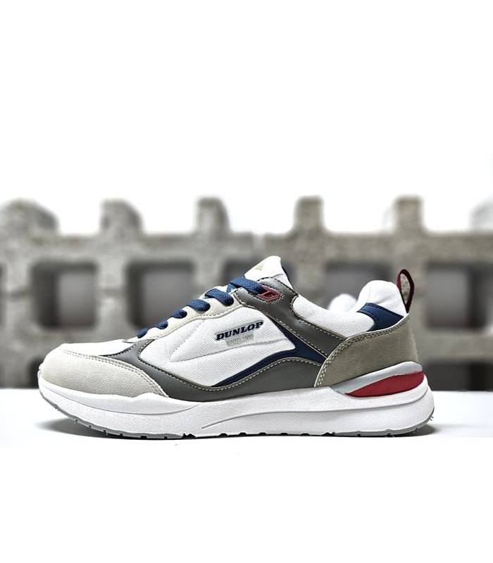 Vista Lateral en Blanco: Zapatillas deportivas casuales Dunlop para hombre en color blanco.