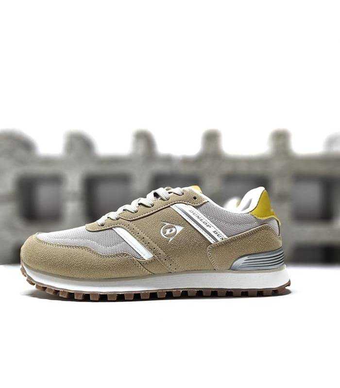 Zapatillas deportivas de hombre Dunlop en color azul con cierre de cordones y diseño moderno, vista lateral