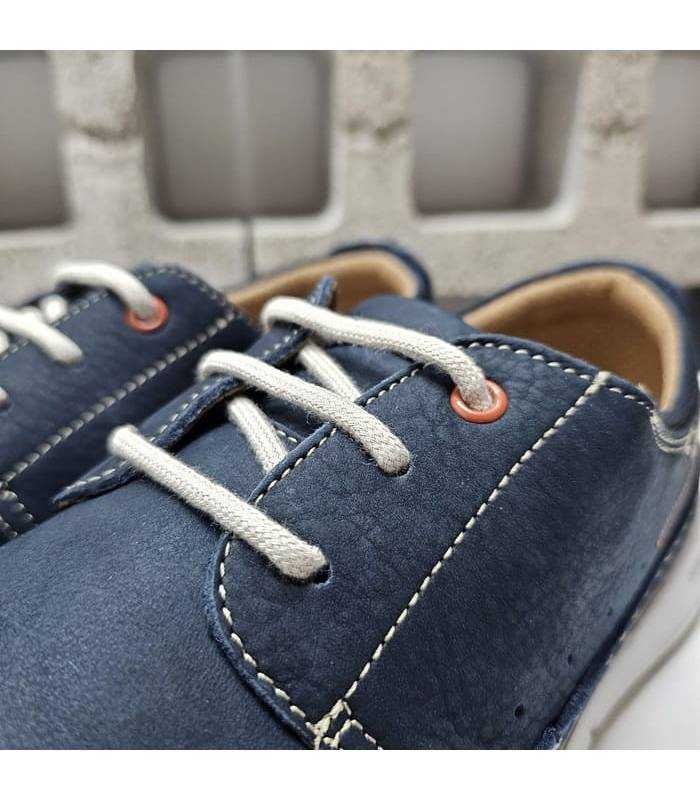 Detalle del cierre con cordones blancos que aportan ajuste personalizado y un toque de contraste elegante.