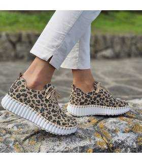 Mujer posando con los zapatos deportivos de animal print