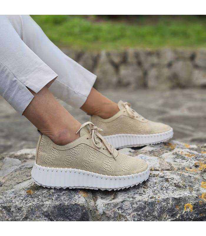 modelo posando con la zapatillas urbana dorada calada de Walk & Fly
