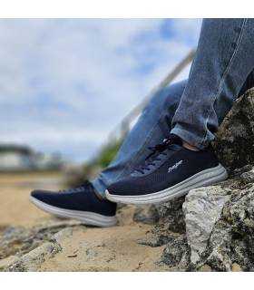 modelo posando junto a la playa con los deportivos azules de verano de Jhayber