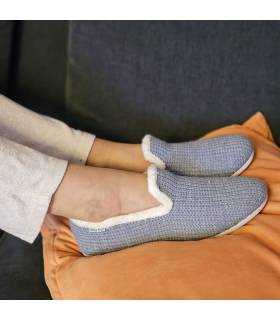 mujer posando con las zapatilñlas de casa para invierno azules puestas