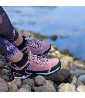 mujer posando con las zapatillas de senderimo impermerables de Elementerre puestas junto al rio