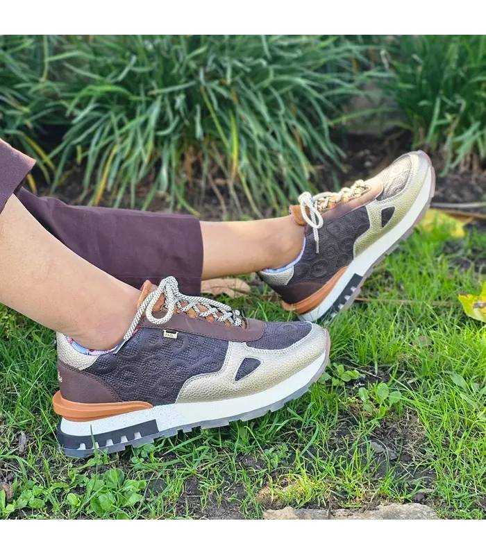 Zapatillas Anekke mujer marrones Lisboa con detalles metalizados puestas con pantalon marron